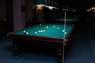 Billiards room. Table with balls and cue