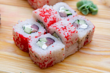 Set of sushi rolls on a wooden board