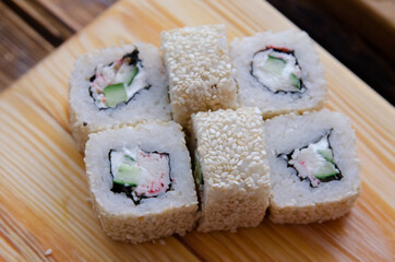 Set of sushi rolls on a wooden board