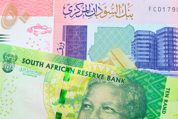 A shiny, green 10 rand bill from South Africa paired with a colorful fifty pound bank note from Sudan.