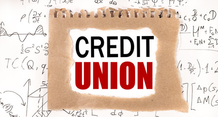 Credit Union. text on white paper on torn paper background, on background of mathematical formulas