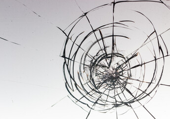 Obraz premium Cracks on the glass on a white background.