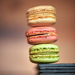 Sweet homemade pistachio flavored french macarons on the background of kitchen