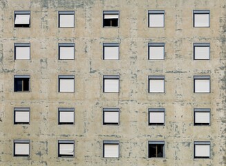 Fototapeta premium Peeling facade of an old abandoned apartment building. Background and texture.
