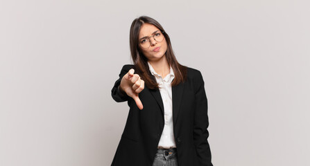 young business woman feeling cross, angry, annoyed, disappointed or displeased, showing thumbs down with a serious look © kues1