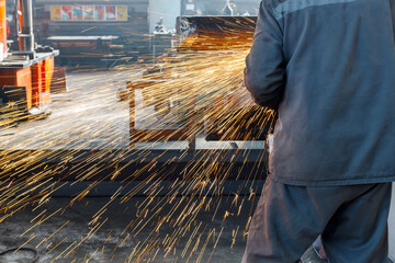 an employee of a metallurgical enterprise performs work on cutting metal