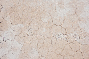 Dry pale sandy surface with cracks