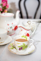 Table arrangement with floral  china cups, saucers, jug and teapot