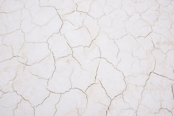 Damaged sandy white surface texture with cracks