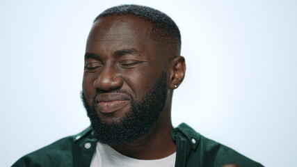 Closeup serious african man waving head no at camera in grey background.
