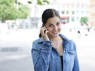 young woman holding mobile phone to her ear