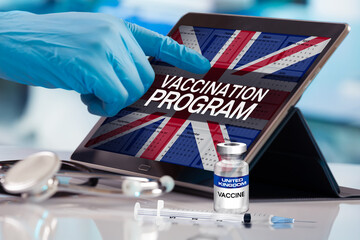 Working with tablet in the program of the vaccination schedule for United Kingdom. Photomontage...