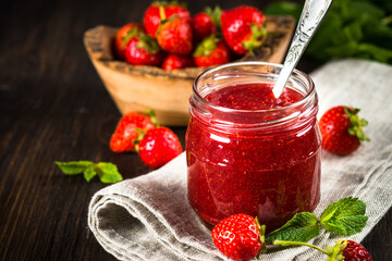 Strawberry jam in the glass jar.