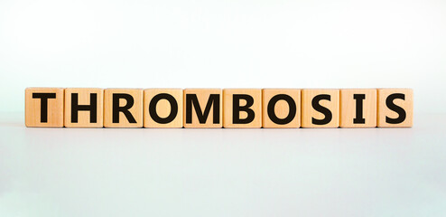 Medical and and thrombosis symbol. Wooden cubes with the word 'thrombosis'. Beautiful white background. Medical and thrombosis concept. Copy space.