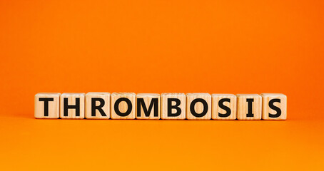 Medical and and thrombosis symbol. Wooden cubes with the word 'thrombosis'. Beautiful orange background. Medical and thrombosis concept. Copy space.