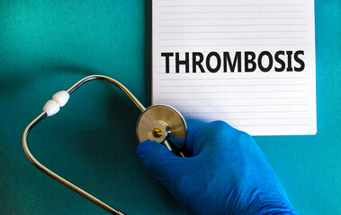 Medical and thrombosis symbol. Doctor hand, stethoscope. White note with the word 'thrombosis'....
