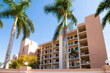 Florida gulf of mexico coast with luxury expensive apartment condominium condo building with palm...