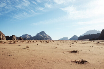 Fototapeta na wymiar Jordan, Wadi Rum Desert: Scenic landscape view of the desert with mountains in the background 
