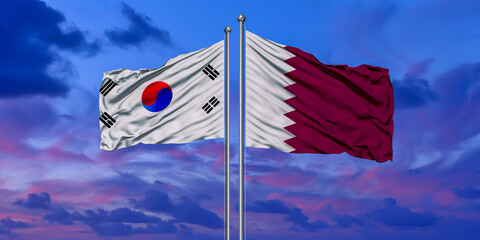 South Korea and Qatar two flags on flagpoles and blue cloudy sky