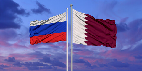 Qatar and Russia two flags on flagpoles and blue cloudy sky
