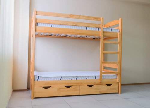 lacquered wooden bunk bed with mattresses