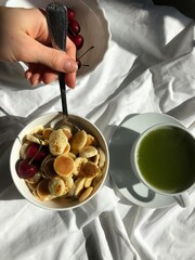 person holding a bowl of pasta