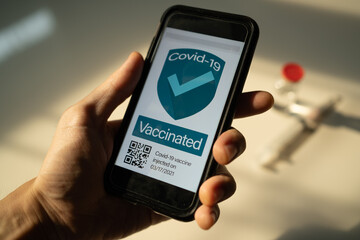 Smartphone showing its screen with Covid-19 vaccine certificate.