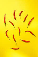 Chili peppers on a yellow background. Spicy chili peppers. vertical photo