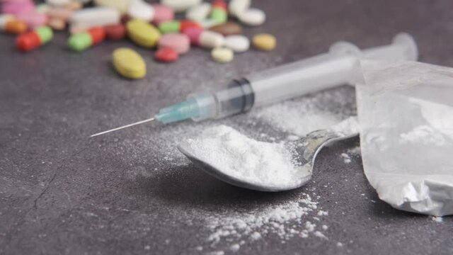 syringe , pills and capsules on table 