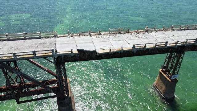 Old Seven Mile bridge in the Florida Keys south of Marathon. Beautiful green Gulf of Mexico waters below. Concrete and iron cannot resist the salty environment and hurricane pressures.