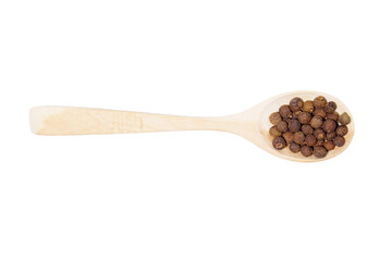 allspice on a wooden spoon isolated on a white background
