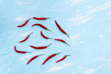 chili pepper on a blue background. Spicy food, Mexican cuisine. copy space