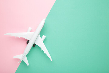 Model airplane on colour pastel color background.