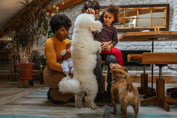 Multiracial family feeling joy around their pets