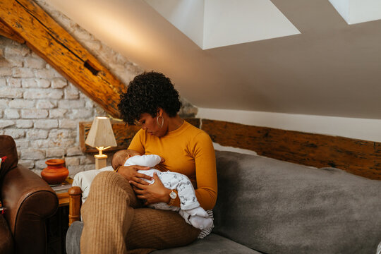 Black Mom Breastfeeding Baby At Home