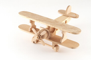Wooden plane with propeller on white background.