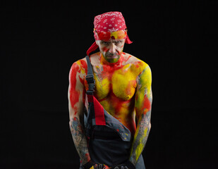 the man is a builder a painter a plasterer all in paint with a brush and a roller