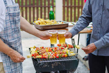 Blurred images ,Barbecue party (BBQ) After work to celebrate the success that can achieve sales target. A group of colleagues held a barbecue party (BBQ) and drinking beer to celebrate success.