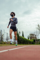 Young man running on the track in the park
