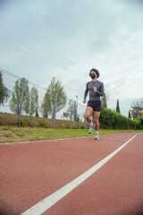 Young man running on the track in the park