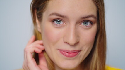 Closeup positive woman sending air kiss to camera on grey background. 