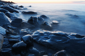 Sea water washing the rocks on the coast.