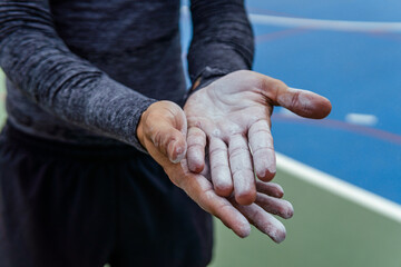 close up of hands with climbing chalk