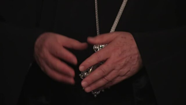 the hands of the Patriarch of Constantinople Bartholomew praying
