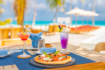 Luxury resort hotel poolside, outdoor restaurant on the beach, ocean and sky, tropical island cafe, tables, food. Summer vacation or holiday, family travel. Palm trees, infinity pool, cocktails, relax