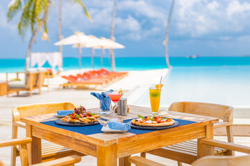 Luxury resort hotel poolside, outdoor restaurant on the beach, ocean and sky, tropical island cafe,...