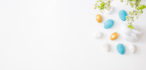 Flat lay easter composition with spring flowers and eggs on white background