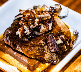Milk chocolate and marshmallow graham cracker smore covered in pecans, birch whiskey toffee sauce and cinnamon 