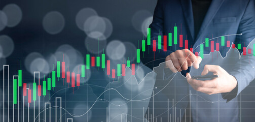 man holding phone with forex graph