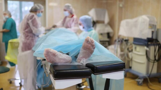 patient feet on operating table, hospital mortality concept, medical error morgue.